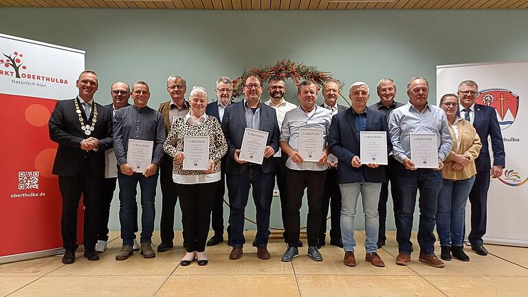 Ehrennadel des Markts Oberthulba verliehen       -  Reihe hinten: (von links) Lothar Henz, Rudi Henz, Ewald Bahn, Jochen Meder, Georg Schießer, Werner Fischer
Reihe vorne: 1. Bürgermeister Mario Götz, Matthias Reuter, Helene Henz, Christof Wigand, Andreas Büchner, Bernd Ließ, Herbert Schmitt, 3. Bürgermeisterin Margot Schottdorf, 2. Bürgermeister Jürgen Kolb