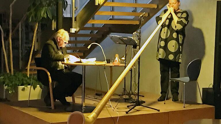 Lesung mit Musik in der Stadtbücherei: Markus Geiselhart mit Alphorn (rechts) und Peter Ahorner am Mikro (links).