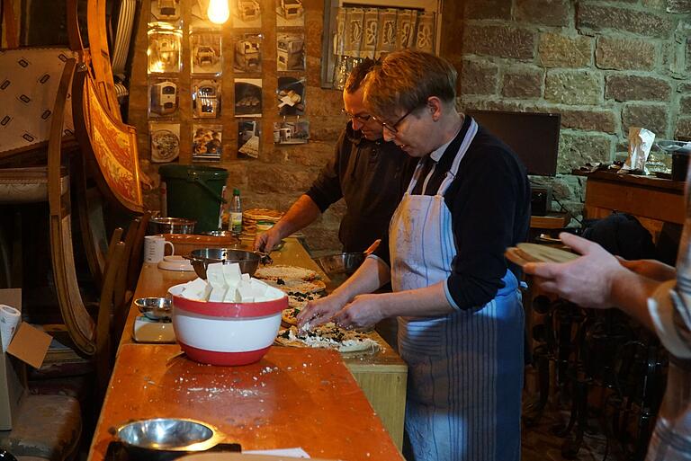 von links: Alexander Schelbert und Nicole Schultheis beim Belegen der Pizzen in der Produktionsstraße von links: Alexander Schelbert und Nicole Schultheis beim Belegen der Pizzen in der Produktionsstraße