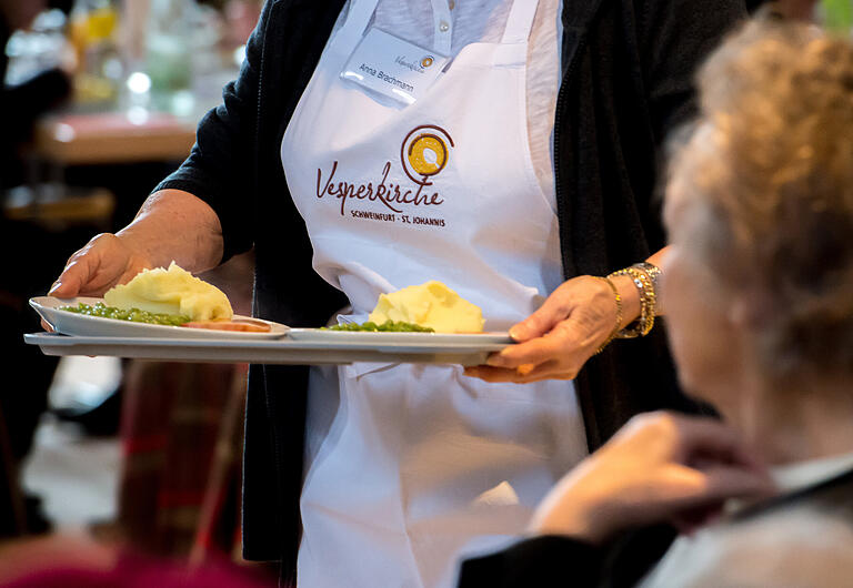 Gastgeber und Gastgeberinnen servieren das Essen und bringen die Gäste an ihren Platz in der Schweinfurter Vesperkirche. Gastgeber und Gastgeberinnen servieren das Essen und bringen die Gäste an ihren Platz in der Schweinfurter Vesperkirche. 