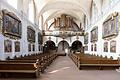 Das Kloster Schönau wurde zum Ende des 12. Jahrhunderts gegründet. Doch das barocke Ensemble geht auf die&nbsp; Würzburger Kapuziner-Minoriten zurück, die 1699 das Kloster übernommen haben. Der Thüngersheimer Maler Georg Sebastian Urlaub schuf die bis heute erhaltene reiche Gemäldeausstattung in Kirche und Mönchchor. Die Bilder der Kreuzwegstationen wurden 2018 restauriert.&nbsp;