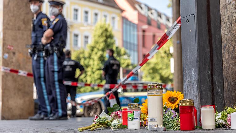 Polizeipräsenz und Blumen vor dem Kaufhaus in der Kaiserstraße in Würzburg kurz nach der Messerattacke: Am 25. Juni 2021 wurden dort drei Menschen getötet und mehrere schwer verletzt.