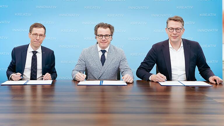 Kunstminister Markus Blume (rechts) mit Chefdirigent Jakub Hrusa und Intendant Marcus Rudolf Axt (links) bei der Vertragsunterzeichnung in München.