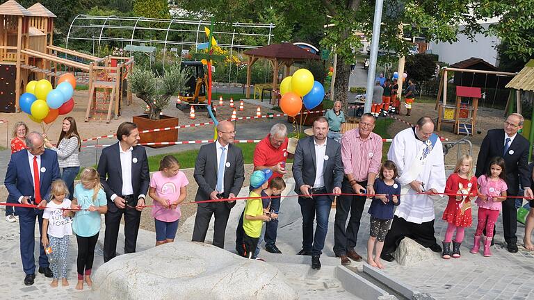 Auch Kinder freuten sich das Band zur Freigabe des Wasserspielplatzes mit durchschneiden zu dürfen. Im Bild die Ehrengäste Roberto Nernosi (von links), Frank Hefner, Frank Klose, Dritter Bürgermeister Bernd Götzendörfer, Bürgermeister Stefan Rottmann, Zweiter Bürgermeister Jürgen Geist, Diakon Frank Menig und Lektor Gerhard Räth.