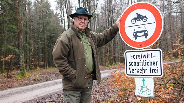 Burgsinner Erhard Reusch mit Schild 'Durchfahrt verboten' an der Hochstraße nach Roßbach. Mit dem Zusatz 'forstwirtschaftlicher Verkehr frei' sieht er Fahrten 'in Ausübung einer jagdlichen Tätigkeit' als erlaubt an.