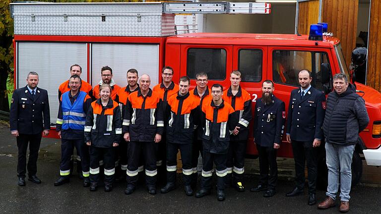 Die Feuerwehrleute nach der Leistungsprüfung vor dem Löschfahrzeug mit den Schiedsrichtern, Kommandant und Gruppenführer Christoph Koberstein (zweiter von links in der blauen Warnweste) und Bürgermeister Johannes Wagenpfahl (rechts).