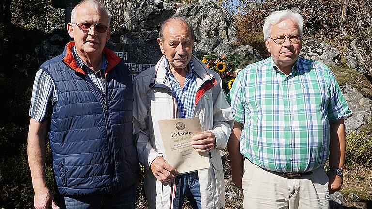 Seit 50 Jahren sorgt Alois Weber (Mitte) vom Rhönklub-Zweigverein Oberelsbach für Sauberkeit und Ordnung am Ehrenmal des Rhönklubs auf dem Heidelstein. Vor der Heidelsteinfeier mäht er die Anlage und achtet darauf, dass alles würdig vorbereitet wird. Für sein ehrenamtliches Engagement überreichte ihm der Rhönklub-Präsident Jürgen Reinhardt das Grüne Band der Rhön. Glückwünsche und Dank sprach ihm auch der Vorsitzende der Saale-Sinn-Region Konrad Tripp aus.