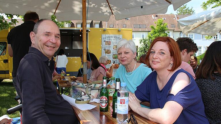 Helmut und Marion Bauer genießen mit Sandra Hartner (rechts) die schöne Atmosphäre bei den Foodtrucks am Main.