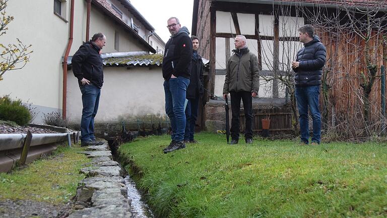 Beim Ortstermin in Frickenhausen informierten sich Wasserwirtschaftsamts-Abteilungsleiter Simon Engel (hinten Mitte) bei Ortssprecher Achim Reß (Zweiter von rechts), Steffen Rapp (Bauhof) und Bürgermeister Michael Kraus (rechts) über das Hochwasserrisiko für zwei Tiny-Häuser, die Marko Reß (vorne) errichten möchte. Beim Ortstermin in Frickenhausen informierten sich Wasserwirtschaftsamts-Abteilungsleiter Simon Engel (hinten Mitte) bei Ortssprecher Achim Reß (Zweiter von rechts), Steffen Rapp (Bauhof) und Bürgermeister Michael Kraus (rechts) über das Hochwasserrisiko für zwei Tiny-Häuser, die Marko Reß (vorne) errichten möchte.