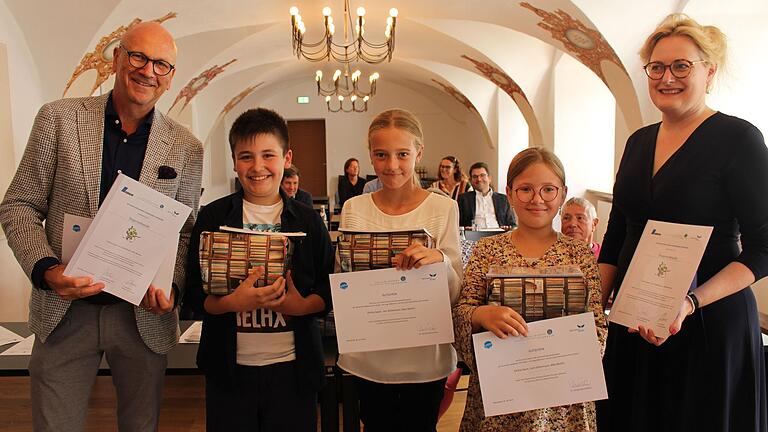 Strahlende Gesichter bei Max Martin, Leni Göttemann  und Emilia Sauer (von links) aus der Klasse 4b der Grundschule Volkach bei der Urkundenverleihung in Abensberg mit Dr. Uwe Brandl, Präsident des Bayerischen Gemeindetags (links) und Dr. Claudia Maria Pecher, Präsidentin der Deutschen Akademie für Kinder- und Jugendliteratur und Leiterin der Landesfachstelle für Büchereien und Bildung im Michaelsbund (rechts im Bild).