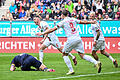 FC Augsburg - 1. FC Heidenheim       -  FCA-Innenverteidiger Jeffrey Gouweleeuw (links) jubelt zusammen mit Kapitän Ermedin Demirovic und Phillip Tietz (von links nach rechts).