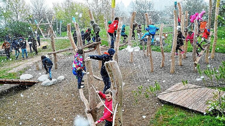 125 000 Euro investiert: Kinder testen den neu gestalteten Keltenspielplatz bei der offiziellen Eröffnung im Schneetreiben.