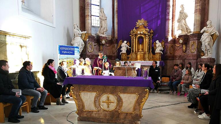 Die Kommunionkinder mit ihren Eltern im Chorraum der St.Sebastian-Kirche in Unterspiesheim während des Streaming-Gottesdienst. Sie gestalteten den Gottesdienst mit, indem sie meditative Gedanken zum Thema 'Weg' vortrugen und auch die Erzahlung vom Propheten Elija vortrugen, der im Vertrauen auf Gott seine Heimat verließ.