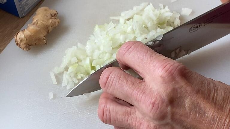 Die mittelgroße Zwiebel wird - zur eigenen Sicherheit im Krallengriff - in feine Würfel geschnitten und anschließend in einem großen Topf mit etwas Butter angeschwitzt. Die mittelgroße Zwiebel wird - zur eigenen Sicherheit im Krallengriff - in feine Würfel geschnitten und anschließend in einem großen Topf mit etwas Butter angeschwitzt.