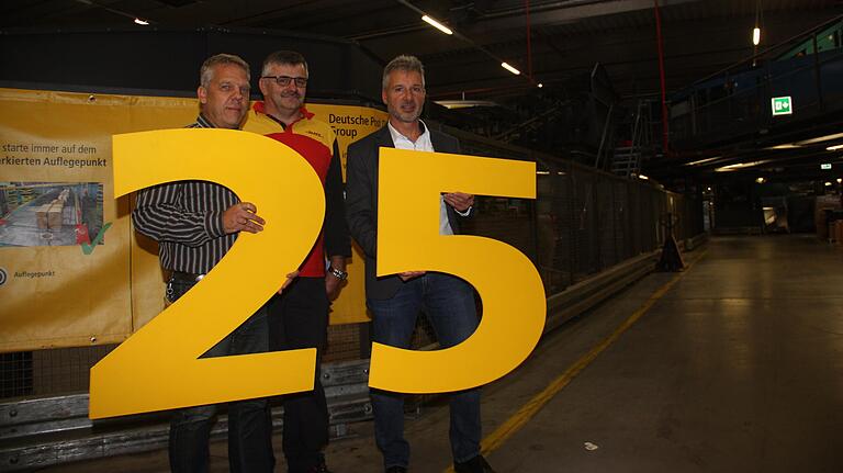 Dasm Paketzentrum von DHL in Kitzingen feiert sein 25-jähriges Bestehen. Im Bild der Leiter des Zentrums, Bernhard Michels (rechts), zusammen mit Schichtleiter Jürgen Göpfert (links) und Rangierer Peter Langer.