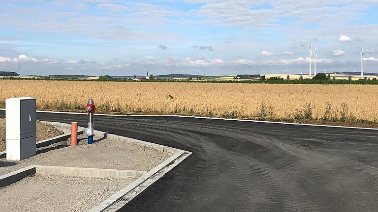 Im Baugebiet 'Am Nützelbach II' sind die Erschließungsstraßen inzwischen asphaltiert. Das Gebiet 'Am Nützelbach III' wird sich direkt westlich anschließen, indem die Straße hier einfach in Richtung Windräder verlängert wird.