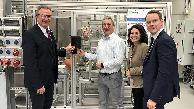 Vertreter der Wirtschaftsförderung des Main-Tauber-Kreises besuchten das Fraunhofer-Institut im Kloster Bronnbach (von links): Dezernent Jochen Müssig, Institutsleiter Dr. Andreas Diegeler, die Leiterin des IZKK Sabrina Rota und Amtsleiter Rico Neubert (Main-Tauber-Kreis) vor der automatisierten Roboteranlage für die Glasfertigungstechnik im Werkstattlabor in Bronnbach. Vertreter der Wirtschaftsförderung des Main-Tauber-Kreises besuchten das Fraunhofer-Institut im Kloster Bronnbach (von links): Dezernent Jochen Müssig, Institutsleiter Dr. Andreas Diegeler, die Leiterin des IZKK Sabrina Rota und Amtsleiter Rico Neubert (Main-Tauber-Kreis) vor der automatisierten Roboteranlage für die Glasfertigungstechnik im Werkstattlabor in Bronnbach.