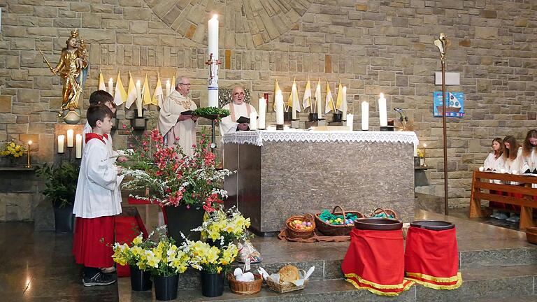 Das Exsultet preist als großes Danklied für das Licht den Sieg Christi über die Mächte der Dunkelheit. Bei der Feier der Osternacht in der Dipbacher Pfarrkirche mit Pfarrer Helmut Rügamer (links) und Diakon Artur Eisenacher. Beim Gloria in der Osternacht läuteten alle Glocken und die Ministrantinnen und Ministranten klingelten kräftig mit den Altarschellen.