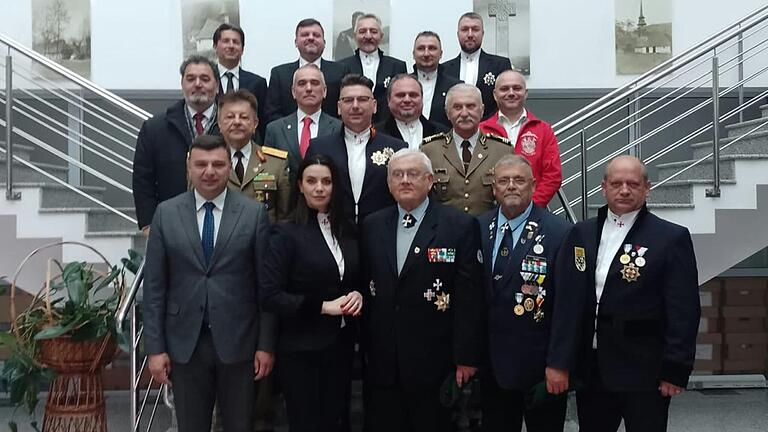 1. Reihe: Sergiu-Ovidiu Bi,lcea Vizepräsident Kreis Arad; Daniela-Maria Boit; Rainer Schmitt, BSB Kreisvorsitzender; Karl-Heinz Vogel, stv. BSB Kreisvorsitzender; Georg Bogdan Außenbeauftragter BSB KV; 2. Reihe: GM a. D. Vasile-Ionel Heredea; Aurelian-Roland Boit; Oberst a. D. Crisan Sandu; 3. Reihe: Oberst d. R. Liviu Lazar; Sebastian Incze; Marcel Mainescu; 4. Reihe: verschiedene weitere Teilnehmer. 1. Reihe: Sergiu-Ovidiu Bi,lcea Vizepräsident Kreis Arad; Daniela-Maria Boit; Rainer Schmitt, BSB Kreisvorsitzender; Karl-Heinz Vogel, stv. BSB Kreisvorsitzender; Georg Bogdan Außenbeauftragter BSB KV; 2. Reihe: GM a. D. Vasile-Ionel Heredea; Aurelian-Roland Boit; Oberst a. D. Crisan Sandu; 3. Reihe: Oberst d. R. Liviu Lazar; Sebastian Incze; Marcel Mainescu; 4. Reihe: verschiedene weitere Teilnehmer.