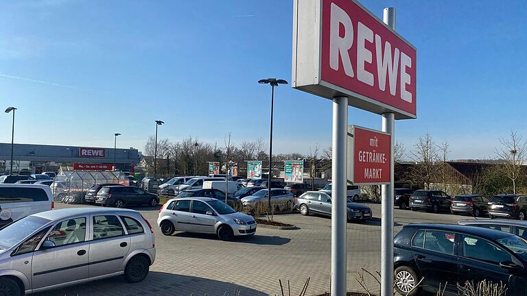 Der Parkplatz des Volkacher Rewe-Marktes wird gegenüber der Einfahrt nach hinten erweitert. Auf dem freien Grundstück (hinter Plakatwänden und Zaun) entsteht ein Getränkemarkt. Der Parkplatz des Volkacher Rewe-Marktes wird gegenüber der Einfahrt nach hinten erweitert. Auf dem freien Grundstück (hinter Plakatwänden und Zaun) entsteht ein Getränkemarkt.