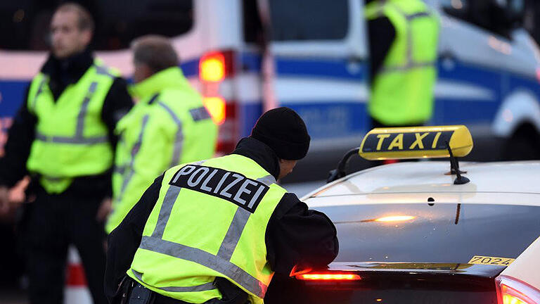 Polizei am Flughafen Schönefeld       -  Polizeibeamte kontrollieren am Flughafen in Schönefeld ein Taxi. Nach dem Terroralarm in Chemnitz haben die Behörden die Sicherheitsvorkehrungen am Flughafen Berlin-Schönefeld erhöht. Foto: Maurizio Gambarini