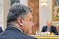 Trafen sich in Minsk: Petro Poroschenko (vorne) und Wladimir Putin  (im Hintergrund).