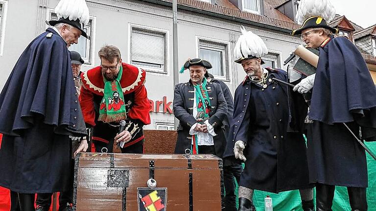 Dieter Blendel, der Generalfeldmarschall der Stadtsoldaten (rechts), übergibt am Rathausplatz in Heidingsfeld mit seinen Hauptmännern Elmar Rohrer (links) und Martin Trageser eine Kiste mit Goldbarren. Giemaul Markus I. und Giemaul-Präsident Christian Reusch versuchen vergebens, die Truhe zu öffnen. Dieter Blendel, der Generalfeldmarschall der Stadtsoldaten (rechts), übergibt am Rathausplatz in Heidingsfeld mit seinen Hauptmännern Elmar Rohrer (links) und Martin Trageser eine Kiste mit Goldbarren. Giemaul Markus I. und Giemaul-Präsident Christian Reusch versuchen vergebens, die Truhe zu öffnen.