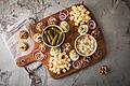 Holländische Borrelhapjes       -  Eine typische niederländische Borrel-Platte mit Filet Americain auf Crackern mit Zwiebel, Ei oder Kapern. Dazu werden Käsewürfel, Cornichons, Silberzwiebeln und gefüllte Eier mit Schnittlauch serviert.