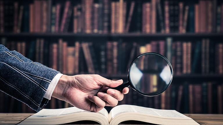 519428032       -  Books and magnifying glass