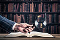 519428032       -  Books and magnifying glass