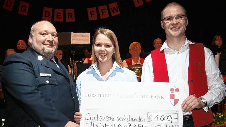 Feuerwehrvereinsvorsitzender Thomas Stegmeier (von links) und Jugendwartin Doris Düring nahmen den 1600-Euro-Spendenscheck für die Jugendarbeit von Dirigent Dieter Lenzer entgegen.