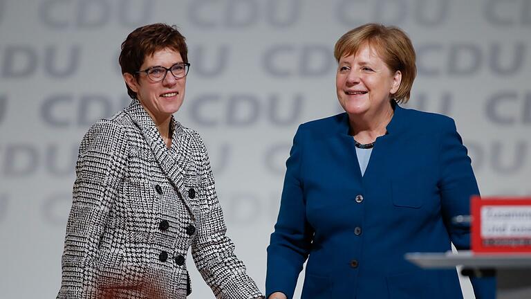 GERMANY-POLITICS-CDU-CONGRESS       -  Germany's conservative Christian Democratic Union (CDU) newly elected leader Annegret Kramp-Karrenbauer (L) is congratulated by German Chancellor Angela Merkel (R) during the CDU congress on December 7, 2018 at a fair hall in Hamburg, northern Germany. - Annegret Kramp-Karrenbauer, a close ally of German Chancellor Angela Merkel, on Friday won a party vote to succeed the veteran leader at the helm of the centre-right CDU. (Photo by Odd ANDERSEN / AFP)