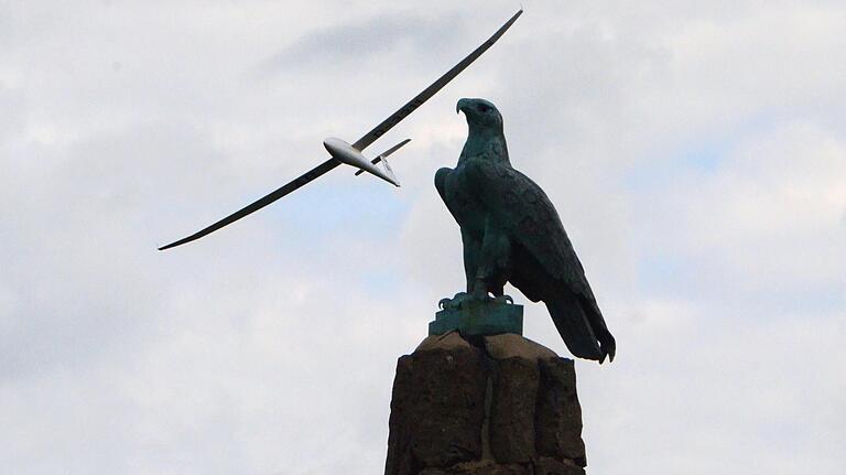 Auch heute noch werden am  Westhang der Wasserkuppe Flüge im Hangflug unternommen. Im Vordergrund das Fliegerdenkmal auf dem höchsten Berg Hessens.