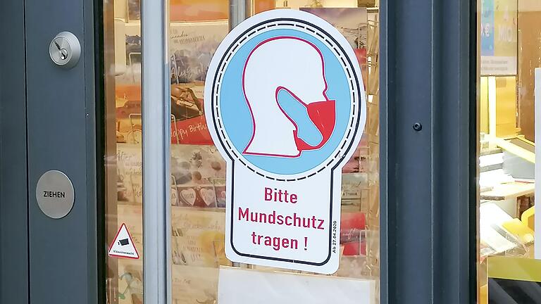 'Ohne' geht gar nichts mehr: Ein Aufkleber 'Bitte Mundschutz tragen' an einer Ladentür weist auf die Corona-Regeln hin. 'Ohne' geht gar nichts mehr: Ein Aufkleber 'Bitte Mundschutz tragen' an einer Ladentür weist auf die Corona-Regeln hin. 
