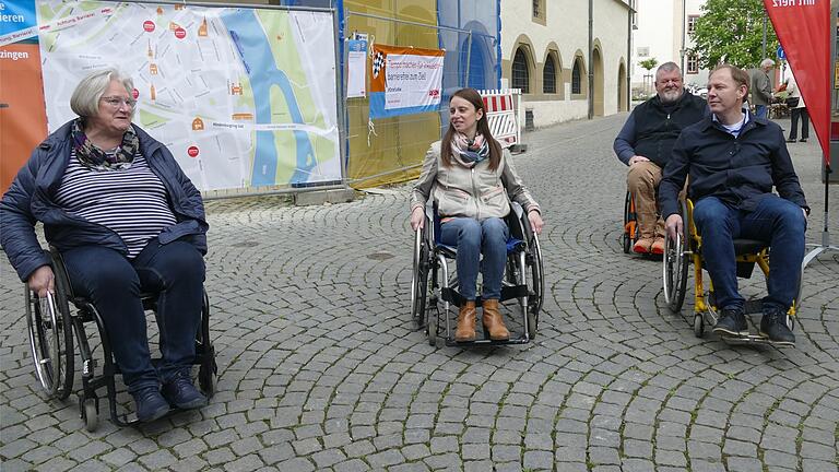 Rollstuhlfahrt über den holprigen Marktplatz (von links) Astrid Glos, Sabrina Stemplowski, Gerd Herold und Stefan Güntner.