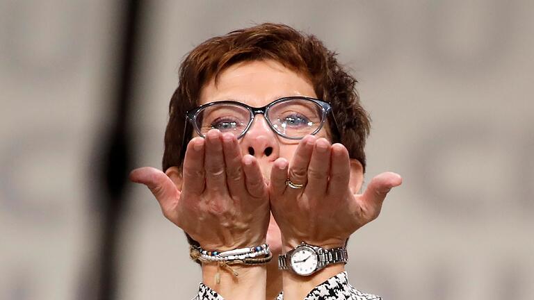 TOPSHOT-GERMANY-POLITICS-CDU-CONGRESS       -  TOPSHOT - Germany's conservative Christian Democratic Union (CDU) party's Secretary General Annegret Kramp-Karrenbauer reacts on stage after she was elected as party's leader during the CDU congress on December 7, 2018 at a fair hall in Hamburg, northern Germany. - German Chancellor Angela Merkel will hand off leadership of her party after nearly two decades at the helm, with the race wide open between a loyal deputy and a longtime rival. (Photo by Odd ANDERSEN / AFP) / ALTERNATIVE CROP