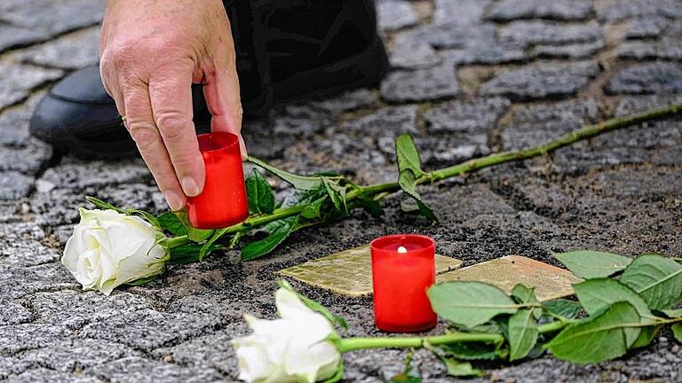 Gedenken mit Kerzen und Blumen: Drei neue Stolpersteine erinnern im Straßenpflaster in Gerolzhofen an weitere in der Nazizeit ermordete jüdische Bürger der Stadt.