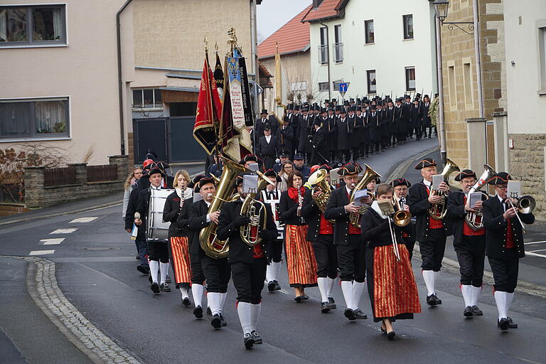 Der feierliche Zug von der Kirche zum Marktplatz mit den Fahnenabordungen und der Steigerwaldkapelle Oberschwarzach.