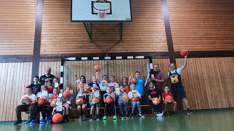 Die Viertklässler am Ende ihrer Trainingseinheit mit (von links) Basketballtrainer Geoffrey Carlisle, Klassenlehrer Stefan Kinkelin und Schulleiter Matthias Schuhmann.