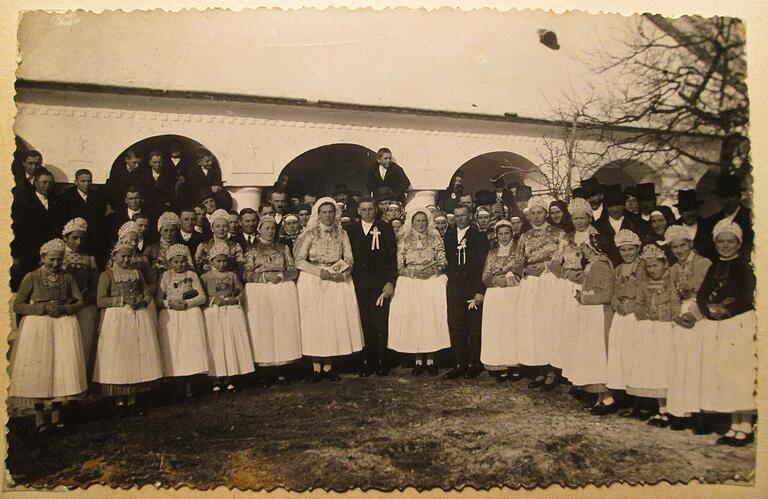 Das Bild zeigt eine Doppel-Hochzeit in Márkó. Das linke der beiden Brautpaar in der Mitte sind Josef und Elisabeth Brenner (geb. Vojts), das Brautpaar rechts daneben sind Josef und Theresia Vojts (geb. Brenner).