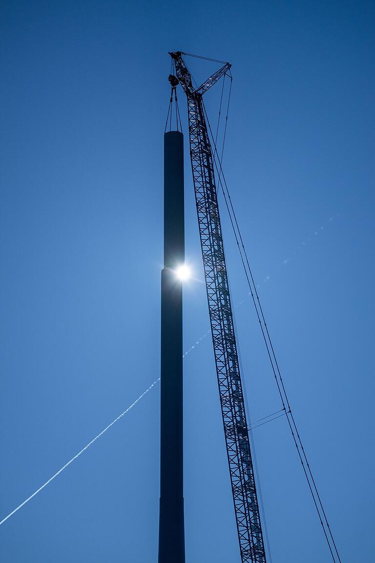 Das letzte Turmteil wird aufgesetzt. Die letzten Sonnenstrahlen blitzen zwischen den Röhren hindurch. Das letzte Turmteil wird aufgesetzt. Die letzten Sonnenstrahlen blitzen zwischen den Röhren hindurch.