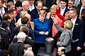 Angela Merkel (CDU/Mitte) wartet auf den Beginn der namentlichen Abstimmung im Plenum im Bundestag.