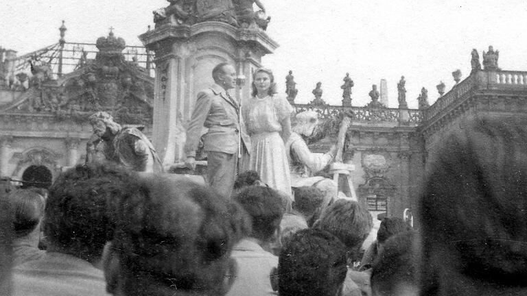 Die Schauspielerin Ingrid Bergman und ihr Kollege Jack Benny treten im Sommer 1945 vor amerikanischen Soldaten am Frankoniabrunnen auf. Im Hintergrund ist die ausgebrannte Residenz zu sehen.