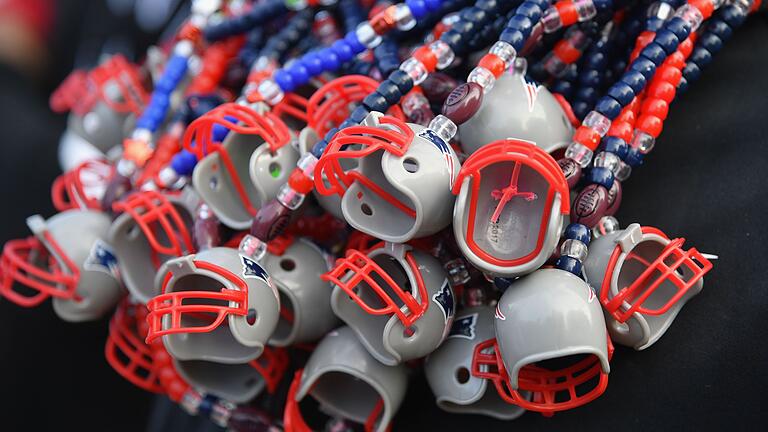 Super Bowl LIII features       -  A vendor wears New England Patriot necklaces at the Super Bowl Experience in Atlanta, Georgia on February 2, 2019. - The New England Patriots will meet the Los Angeles Ram at Super Bowl LIII on February 3rd. (Photo by Angela Weiss / AFP)