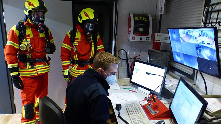 Andreas Keppler weist im Kontrollraum zwei Feuerwehrmänner für die Teststrecke ein. Andreas Keppler weist im Kontrollraum zwei Feuerwehrmänner für die Teststrecke ein.