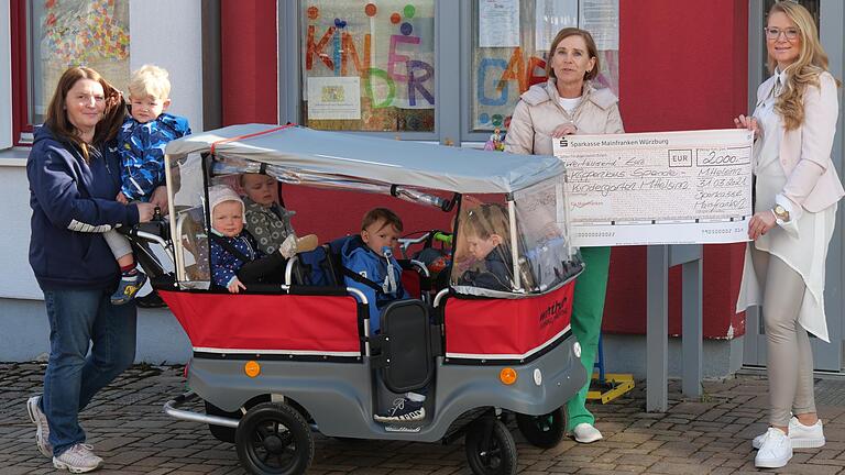 Stolz grüßen die Kleinkinder der Mittelsinner Kita aus ihrem neuen Krippenbus, mit dem sie Ausflüge durch das Dorf unternehmen. Bei der Übergabe der Spende von 2000 Euro durch den Hauptsponsor Sparkasse Mainfranken freuten sich (von links) Gruppenleiterin Silke Kreuzer, Kindergartenleiterin Gabriele Unger und Vermögensberaterin Stefanie Meinunger.