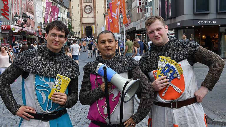 Im Kettenhemd rühren (v. l.) Thomas Schneider, Alexander Pfeffer und Maximilian Schneider in der Würzburger Fußgängerzone die Werbetrommel für die Röttinger Frankenfestspiele.