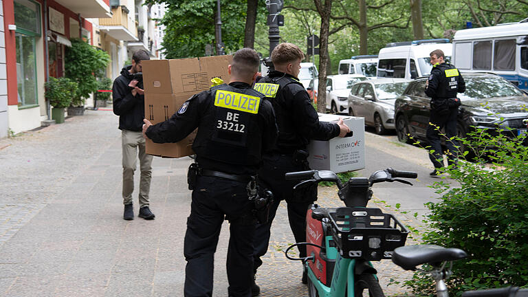 Durchsuchungen bei Letzter Generation - Berlin.jpeg       -  Polizeibeamte tragen in Berlin nach einer Durchsuchung einer Wohnung der Gruppe Letzter Generation Kartons zu einem Einsatzwagen.