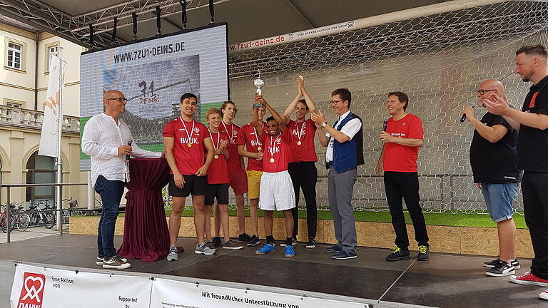 Oberbürgermeister Christian Schuchardt (Mitte) zusammen mit dem Sieger-Team vor dem Tor aus dem 7:1-Spiel der Fußball-WM 2014 in Brasilien. Foto: Aaron Niemeyer