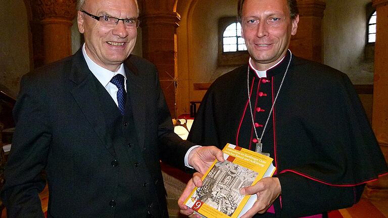 Co-Autor Werner Zeißner (links) überreichte Weihbischof Herwig Gössl ein druckfrisches Exemplar des neuen Buches.